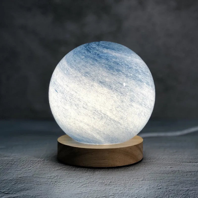 Nordic style Planet Light table lamp with transparent glass shade, shown in emerald green colour.