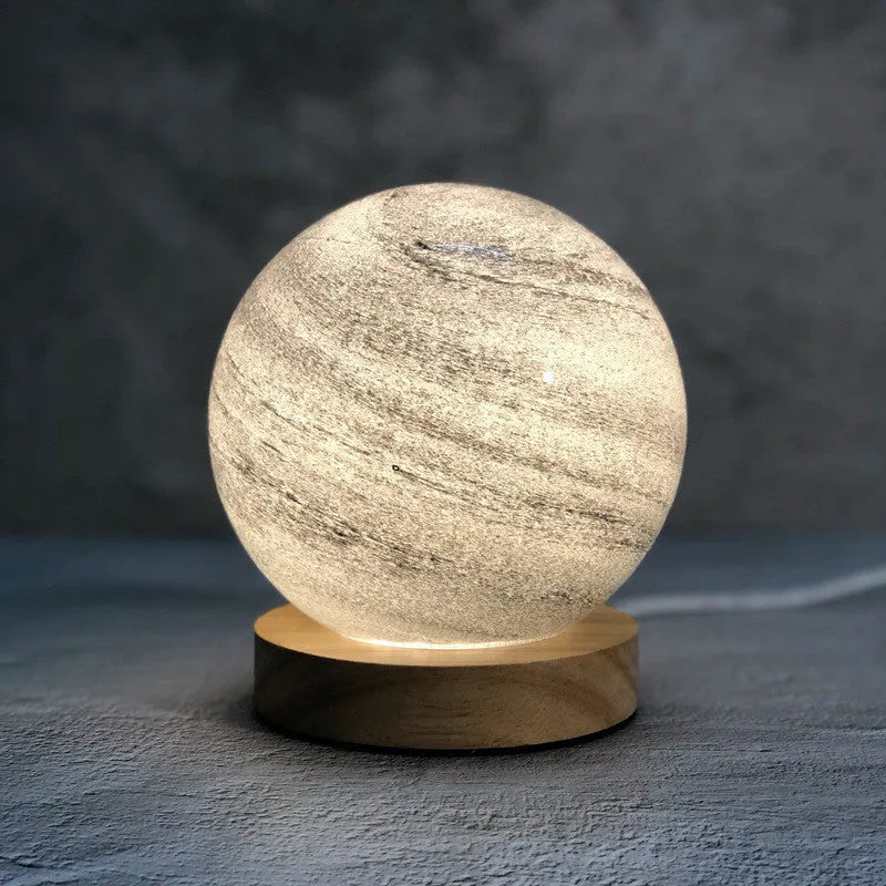 Nordic style Planet Light table lamp with transparent glass shade, shown in emerald green colour.