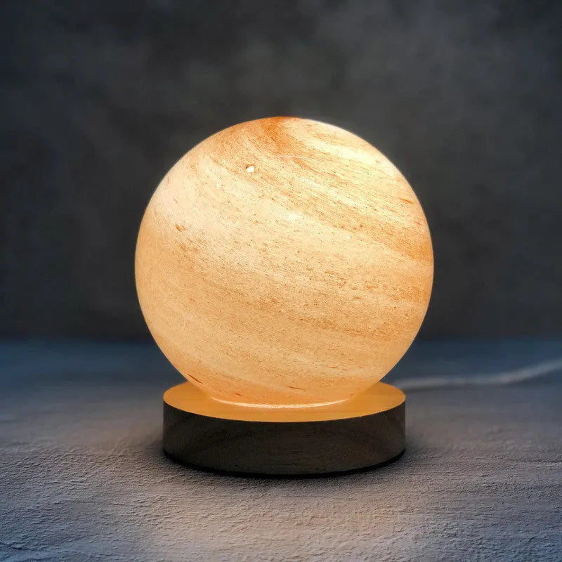 Nordic style Planet Light table lamp with transparent glass shade, shown in emerald green colour.