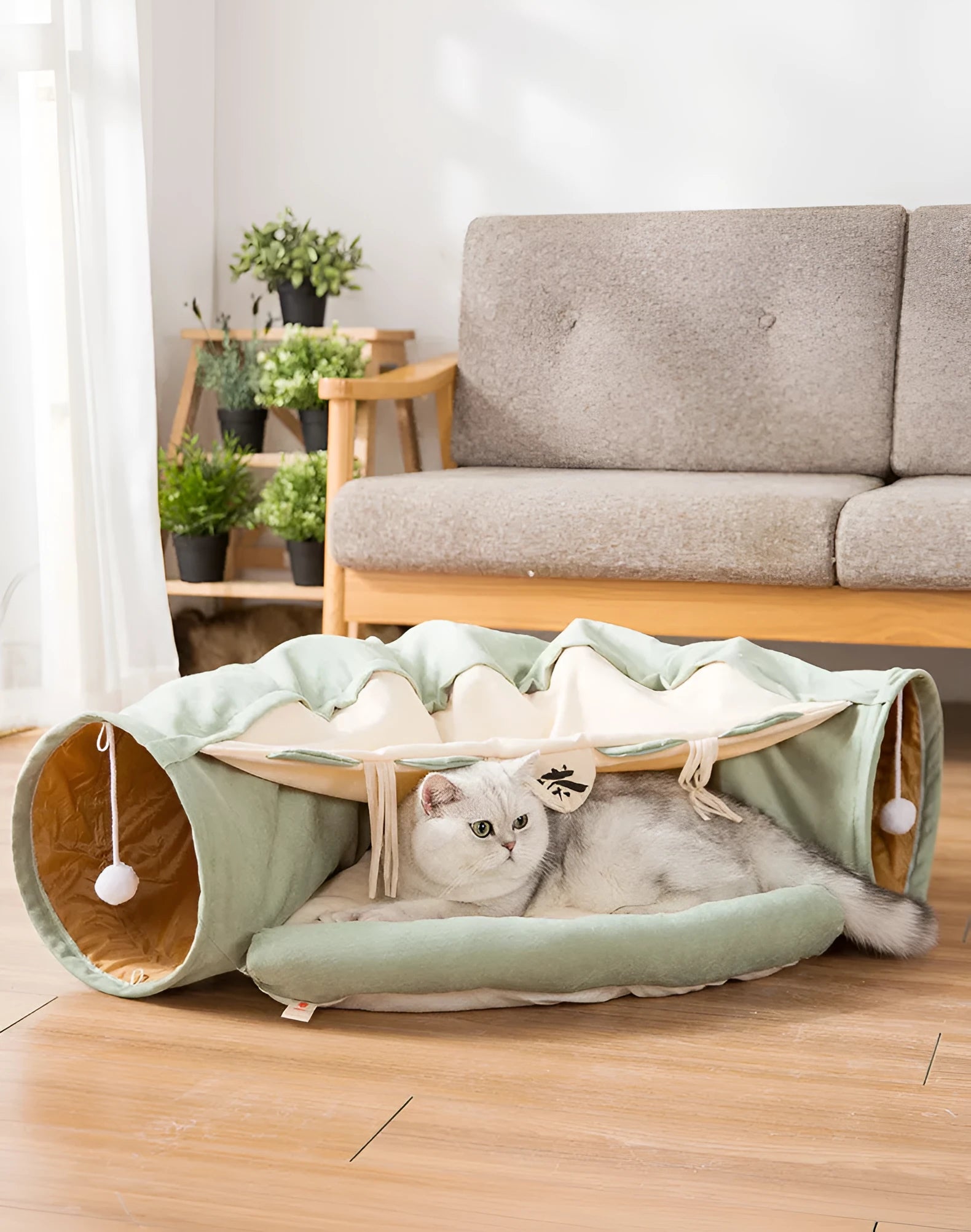 Collapsible cloth cat tunnel in Pink colour with visible opening, measuring 45x50x22 cm, on wooden floor
