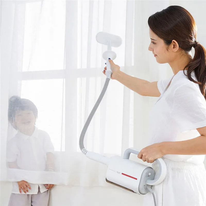 White Deerma DEM-ZQ610 steam cleaner unit with assorted brush heads including glass scraper and mop.