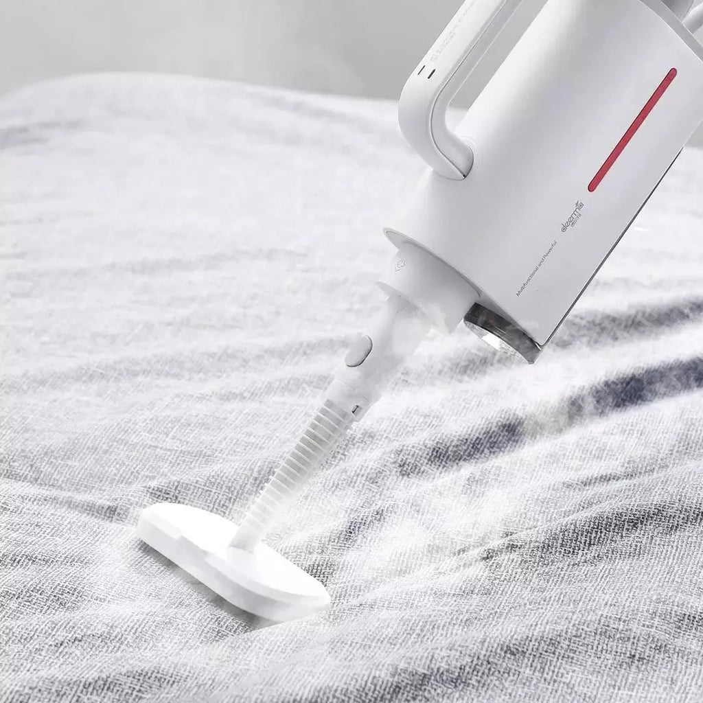 White Deerma DEM-ZQ610 steam cleaner unit with assorted brush heads including glass scraper and mop.