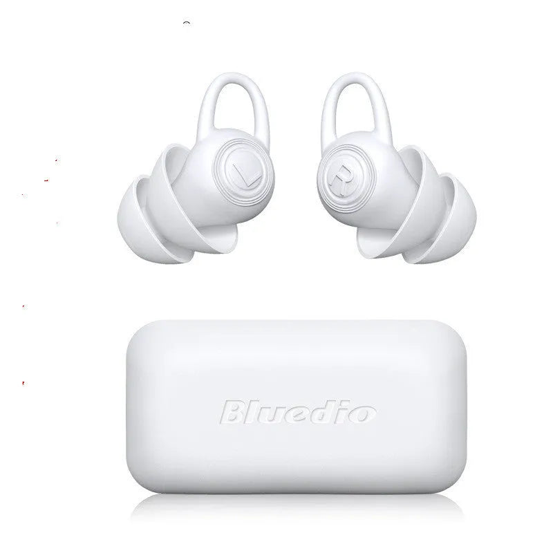 A pair of white soft silicone ear plugs for noise reduction on a plain background.