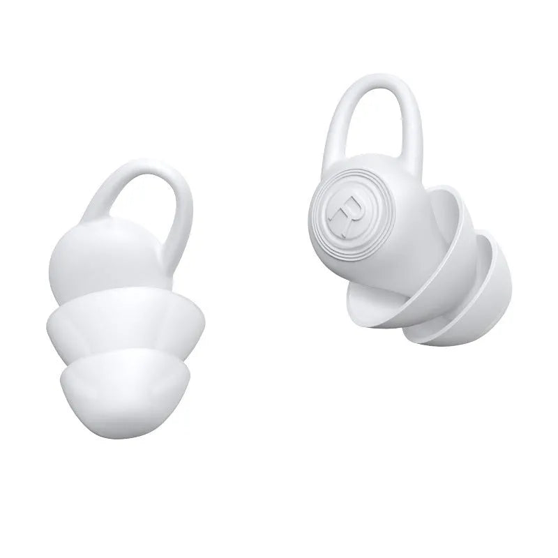 A pair of white soft silicone ear plugs for noise reduction on a plain background.