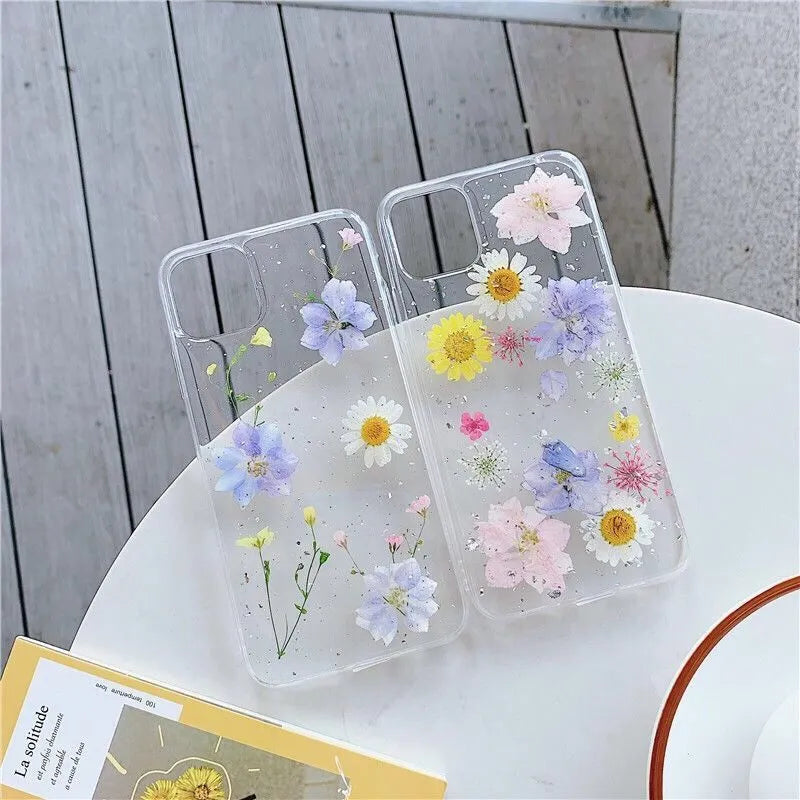 Transparent silicone phone case with real dried daisy flower and glitter design in blue and pink