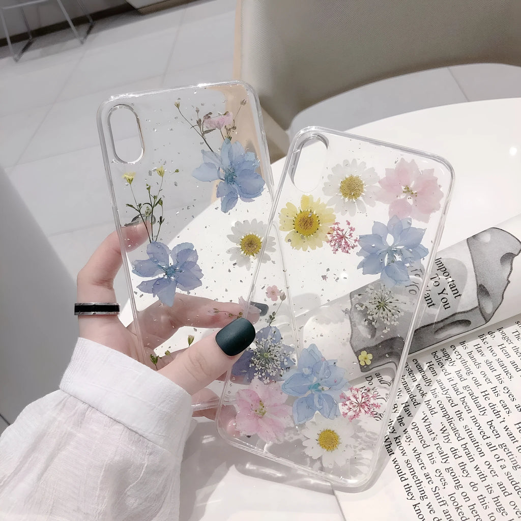Transparent silicone phone case with real dried daisy flower and glitter design in blue and pink