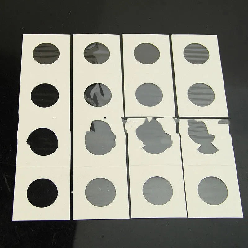 Set of 50 white paper coin protector clips for commemorative coins in a transparent OPP bag.