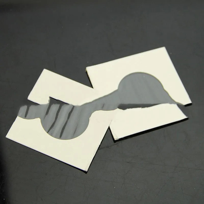 Set of 50 white paper coin protector clips for commemorative coins in a transparent OPP bag.