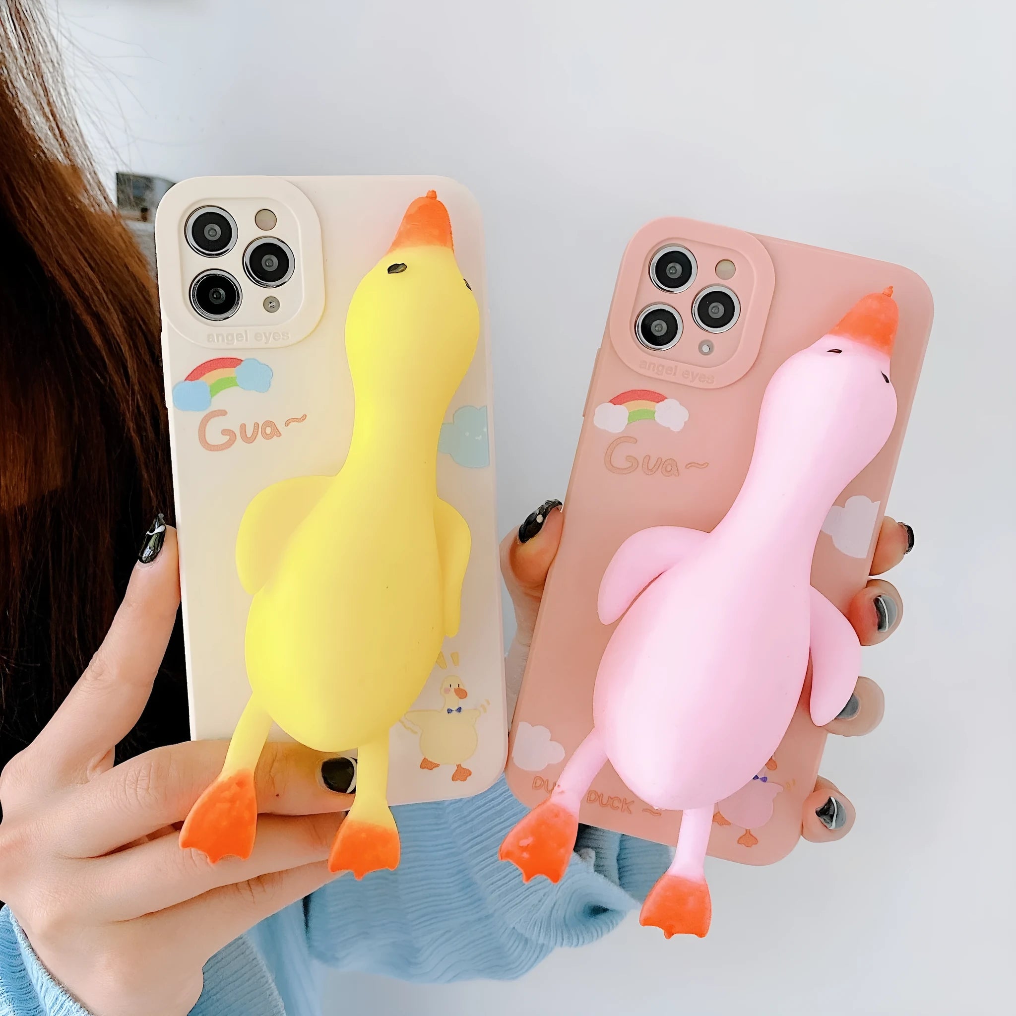 Cartoon-printed silicone TPU phone case for Apple iPhone in yellow, white, and pink colour options.