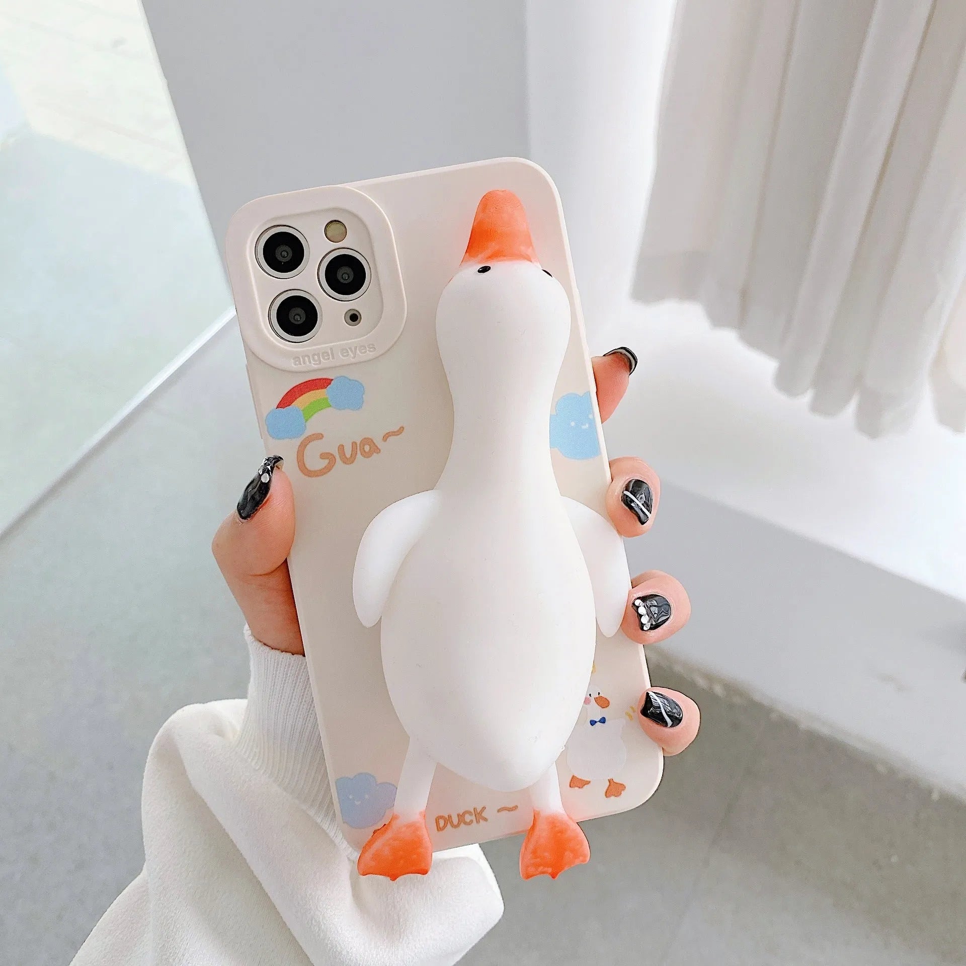 Cartoon-printed silicone TPU phone case for Apple iPhone in yellow, white, and pink colour options.