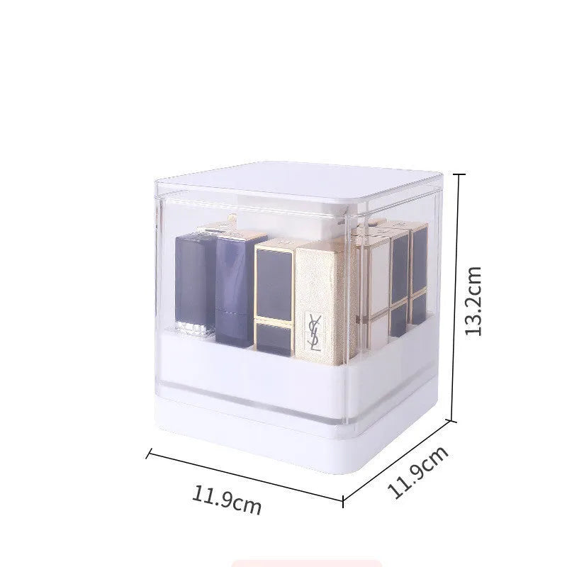 Pink press-lift lipstick storage box with dust cover on a desktop.