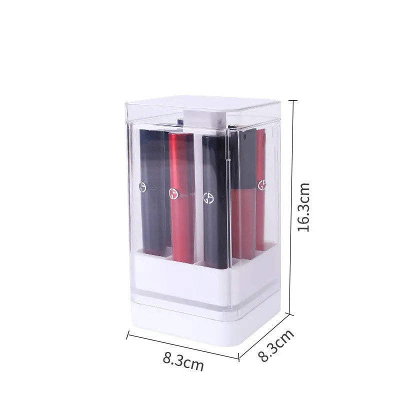 Pink press-lift lipstick storage box with dust cover on a desktop.