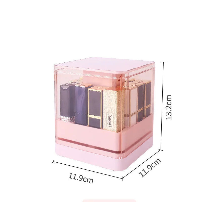Pink press-lift lipstick storage box with dust cover on a desktop.