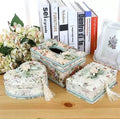 Ceramic jewellery and tissue storage box in bright apricot colour on a table.