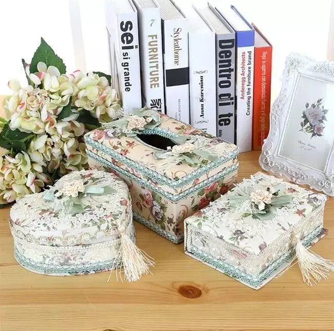 Ceramic jewellery and tissue storage box in bright apricot colour on a table.