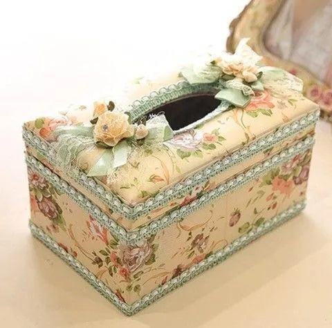 Ceramic jewellery and tissue storage box in bright apricot colour on a table.