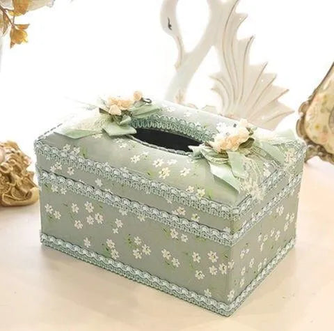 Ceramic jewellery and tissue storage box in bright apricot colour on a table.