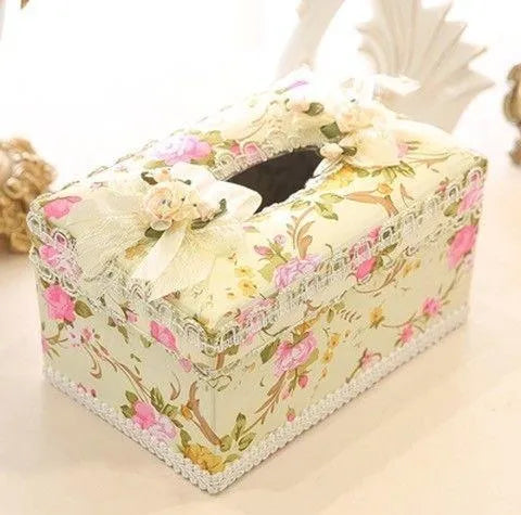 Ceramic jewellery and tissue storage box in bright apricot colour on a table.