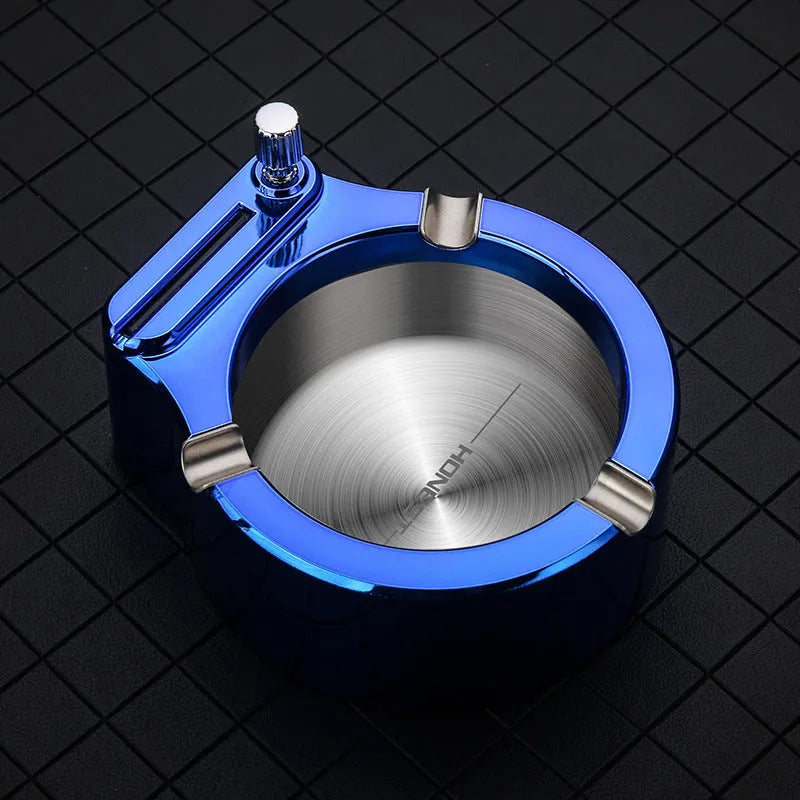 Large blue metal ashtray with integrated sliding stick permanent match lighter and three cigarette slots.
