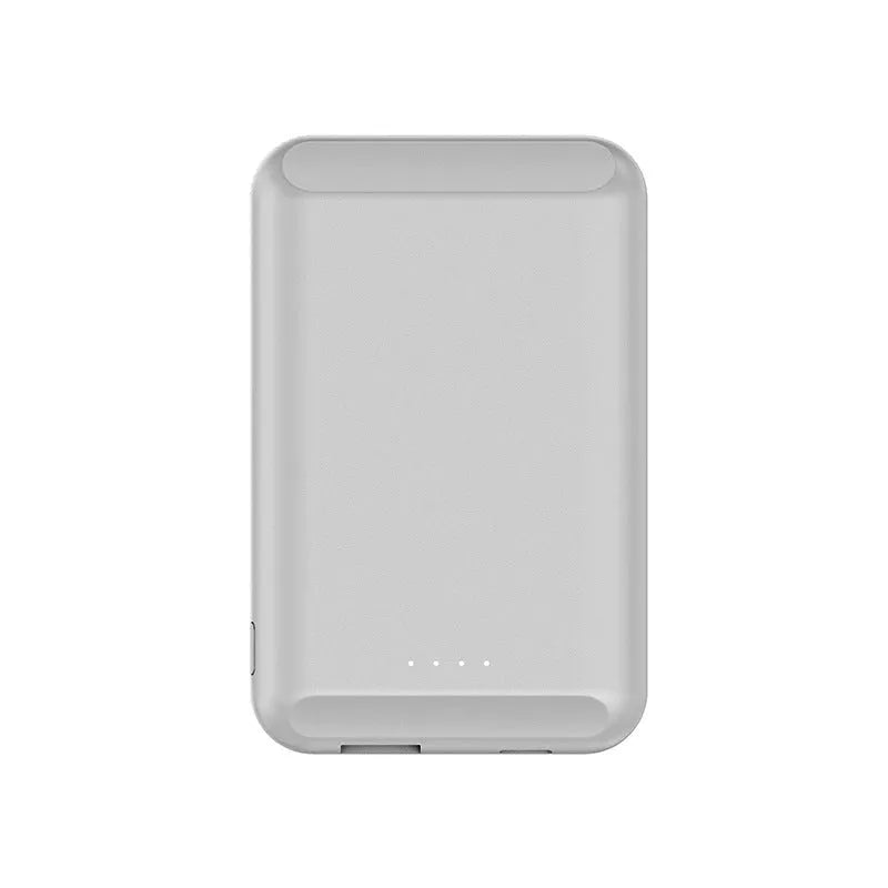 A black magnetic wireless power bank attached to the back of an iPhone for charging.
