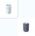 Pink portable car humidifier with coloured lights on a car dashboard next to a USB cable