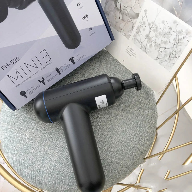 Black, red, and grey fascia gun muscle massager with USB cable