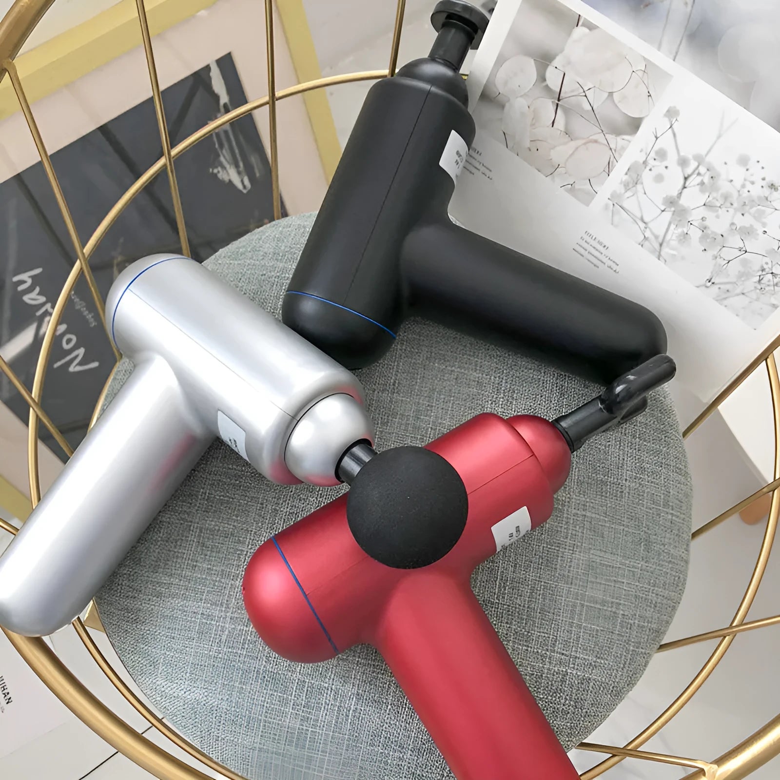 Black, red, and grey fascia gun muscle massager with USB cable
