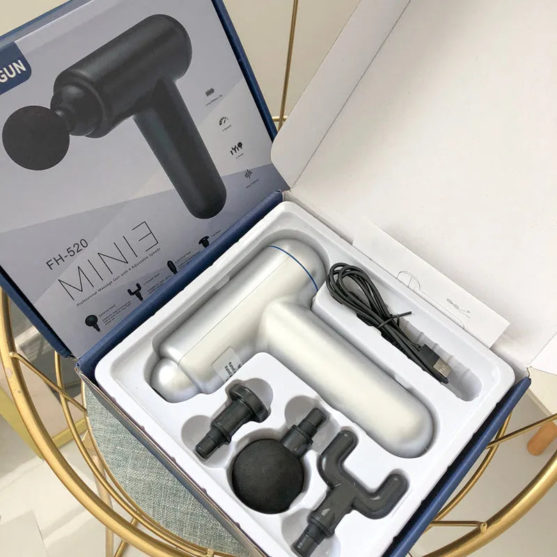Black, red, and grey fascia gun muscle massager with USB cable