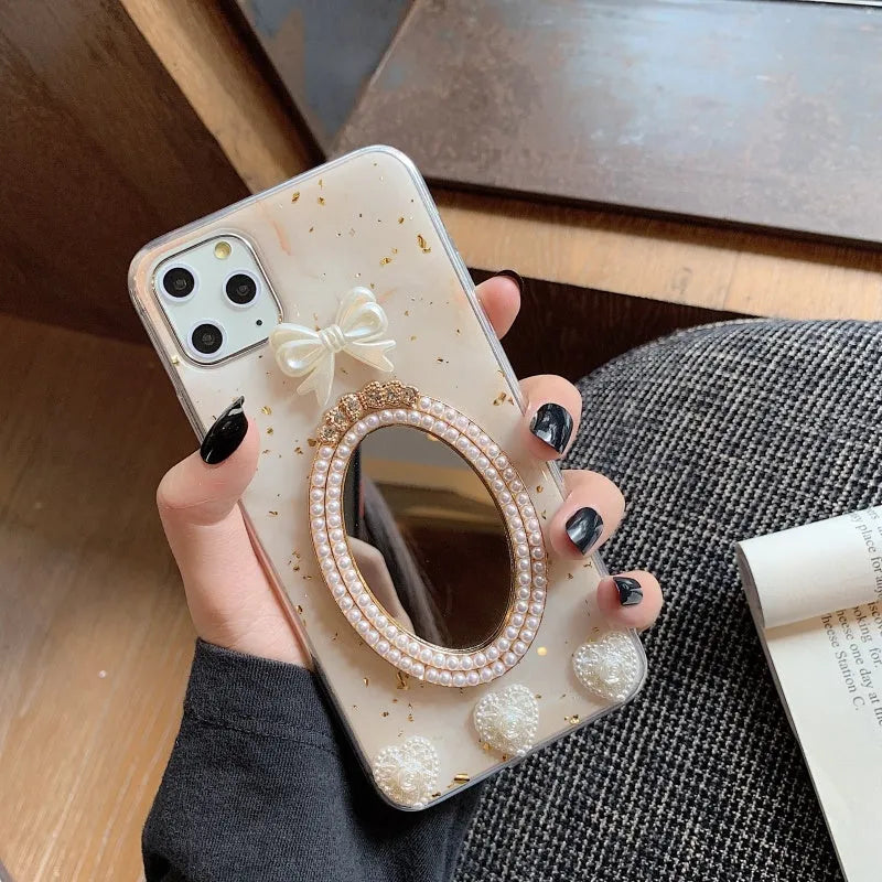 Brown marble pattern silicone iPhone case with rhinestone bowknot and mirror front, shown next to a white colour option.
