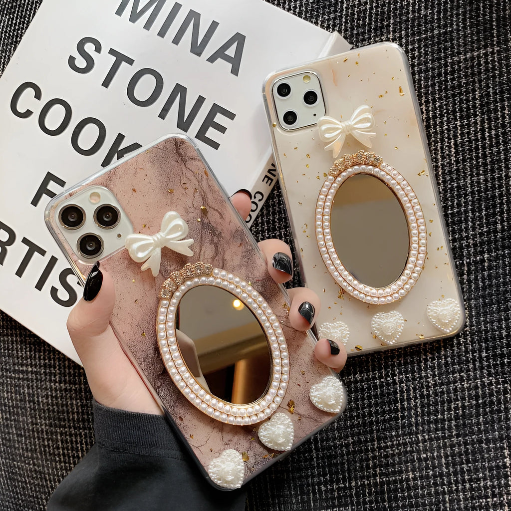 Brown marble pattern silicone iPhone case with rhinestone bowknot and mirror front, shown next to a white colour option.