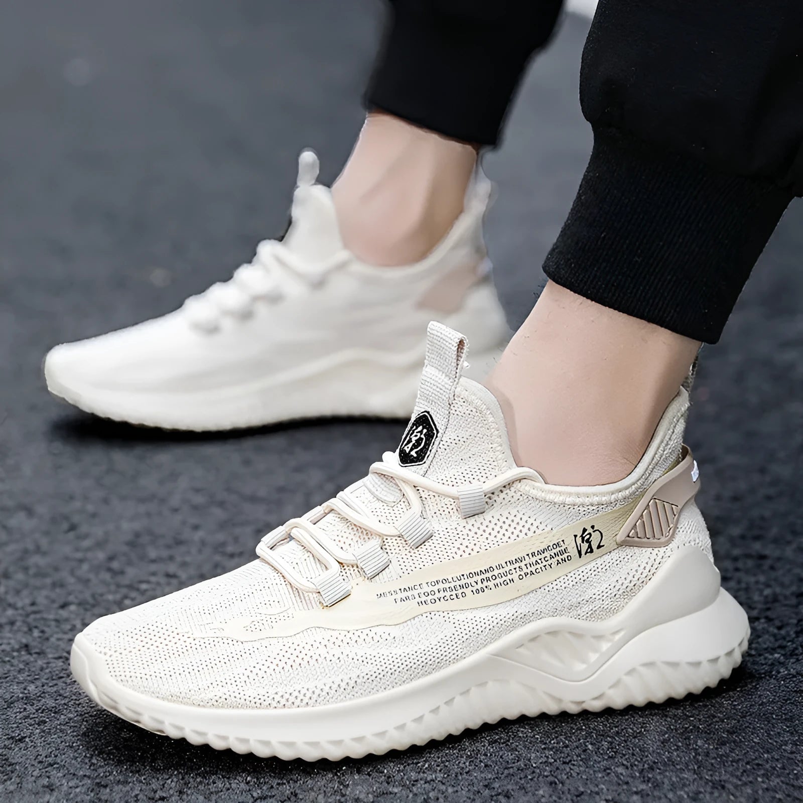 Men's low-top white mesh sports shoes with rubber sole and front lacing on a plain background