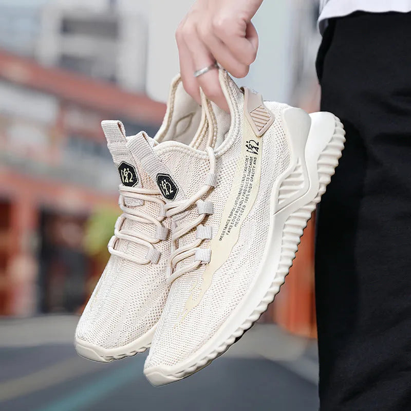 Men's low-top white mesh sports shoes with rubber sole and front lacing on a plain background