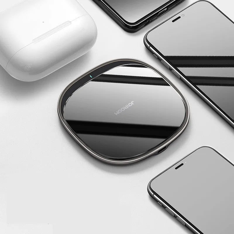 Square black 15W wireless charging pad with glass top and thin zinc alloy frame on a wooden desk