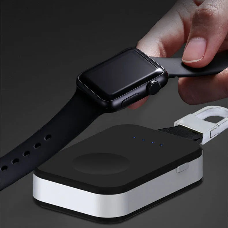 Black Apple Watch portable wireless power bank on a keyring showing compact size.