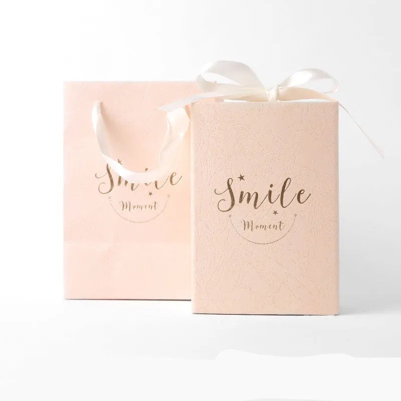 Small bronzed cardboard gift box in blue, showing dimensions 9.5cm by 14.5cm by 6cm.
