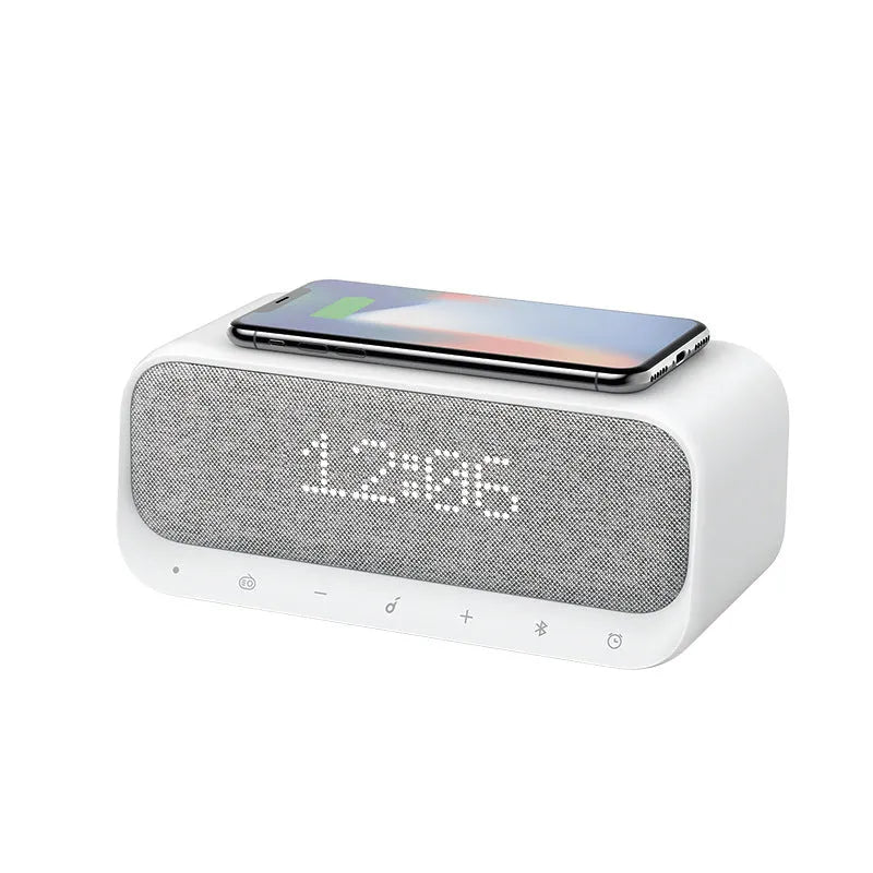 Anker Soundcore white Bluetooth speaker with wireless charging pad and display showing time