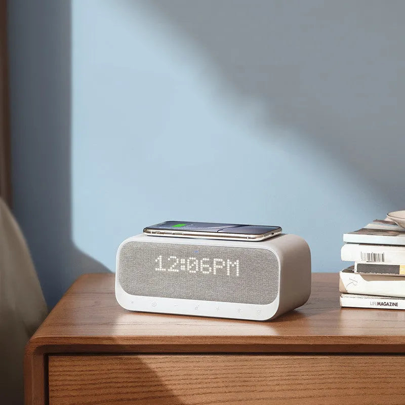 Anker Soundcore white Bluetooth speaker with wireless charging pad and display showing time