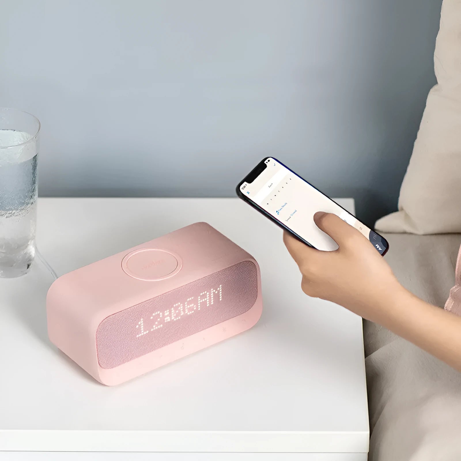 Anker Soundcore white Bluetooth speaker with wireless charging pad and display showing time