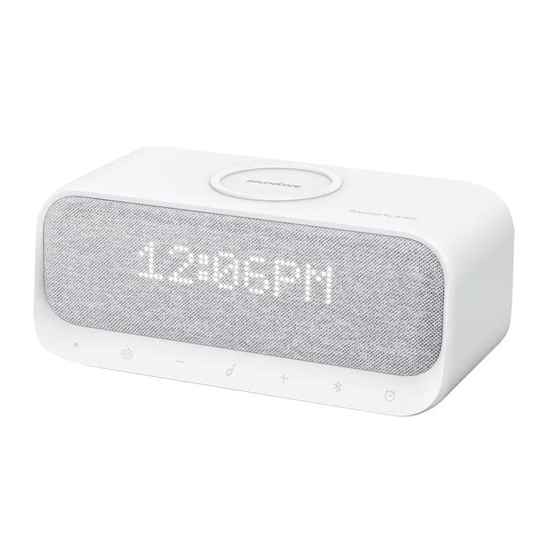 Anker Soundcore white Bluetooth speaker with wireless charging pad and display showing time
