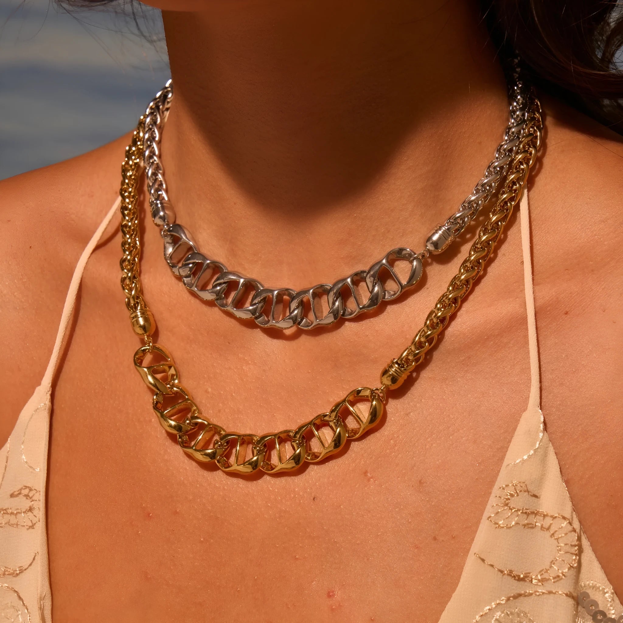 Gold and steel stainless steel geometric pendant necklace with regular chain.