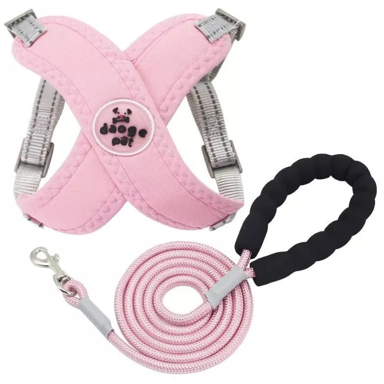 Pink polyester dog vest with an attached hand holding rope laid flat