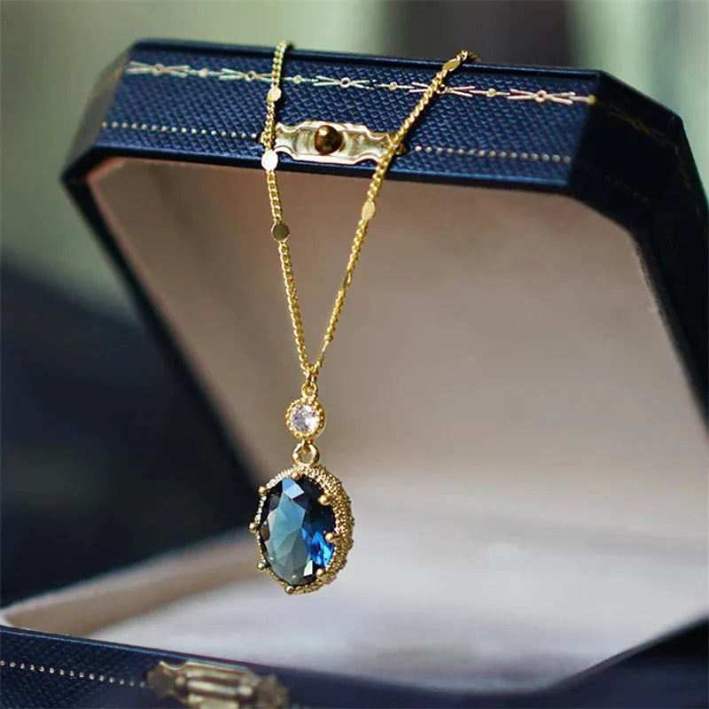Gold geometric pendant necklace with French retro style on a model.