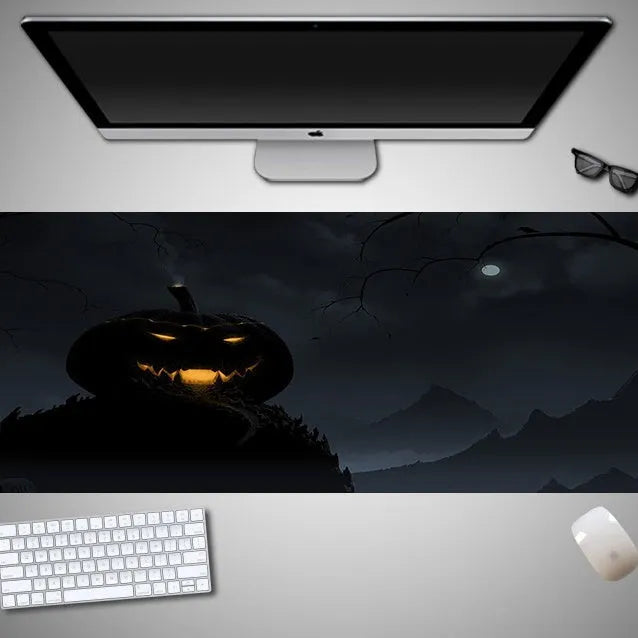 Large Halloween patterned gaming mouse pad on a desk showing non-slip rubber base and extra-long design.
