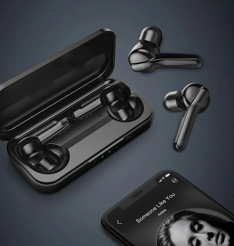 Black and white true wireless stereo earbuds with a charging case on a table