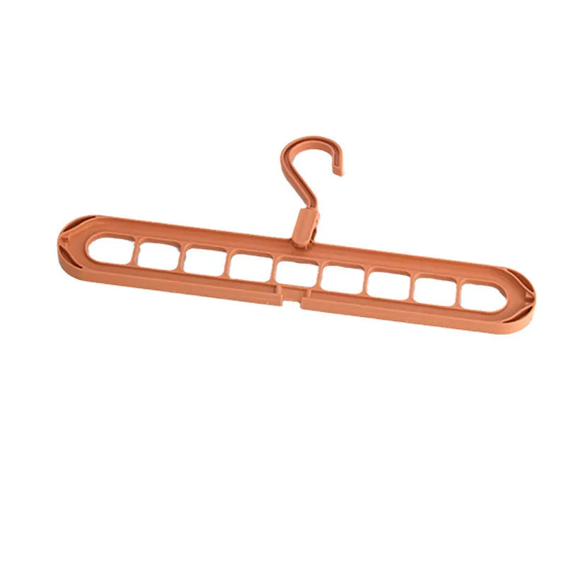 Green nine-hole plastic folding hanger for trousers and skirts showing multiple garment hanging points