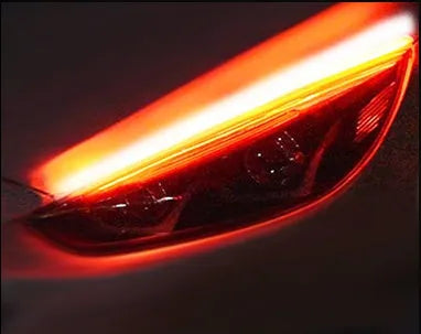 Flexible silicone car LED light strip for daytime running and flowing turn signals, showing wire connections.