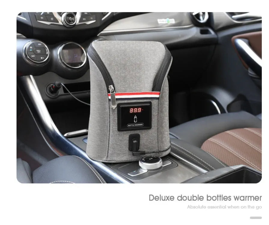 Grey Oxford cloth portable car USB baby bottle warmer with display, shown with two bottles and a 12V car charger.