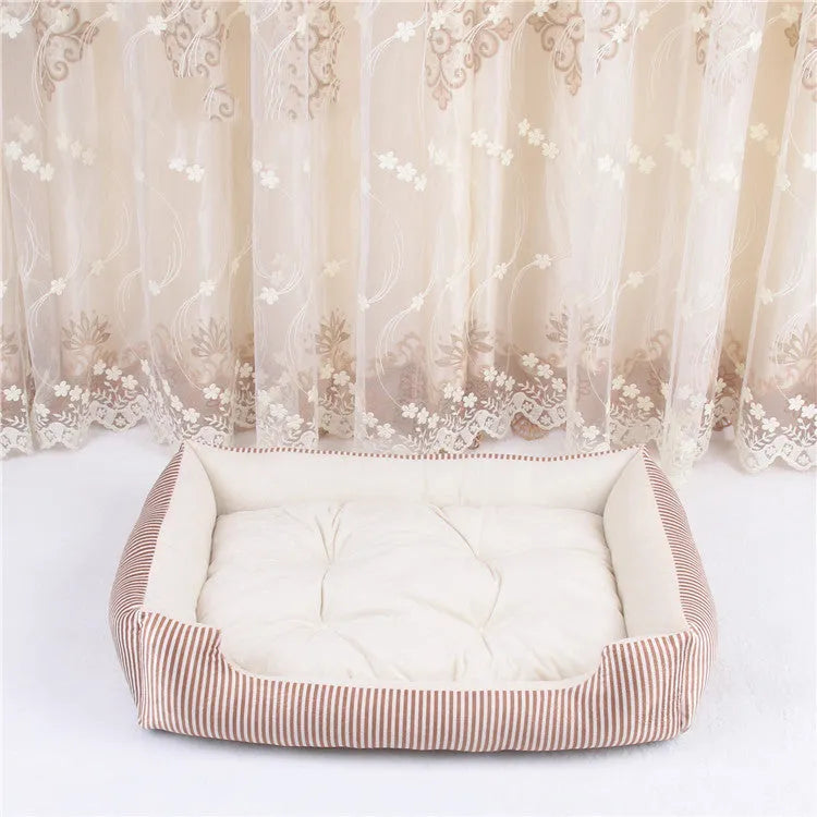 A grey and white striped bolster-sided pet bed for dogs or cats with a removable cloth cover.