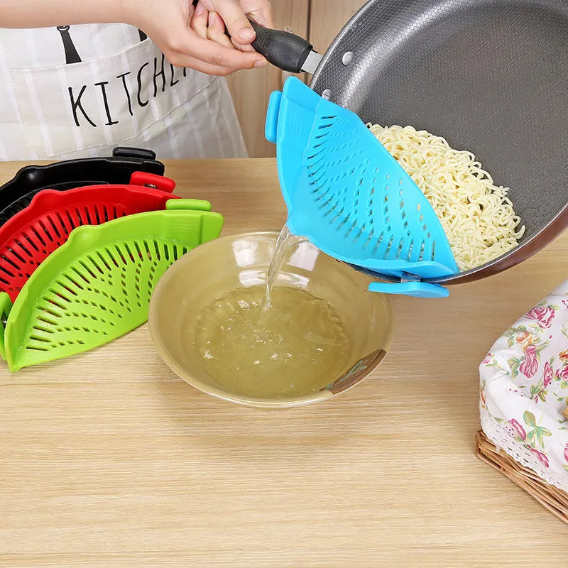 Silicone clip-on funnel strainer attached to a pot rim for draining liquids.
