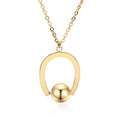 Gold tone stainless steel necklace with geometric pendant on a cross chain, shown adjusted to a medium length.
